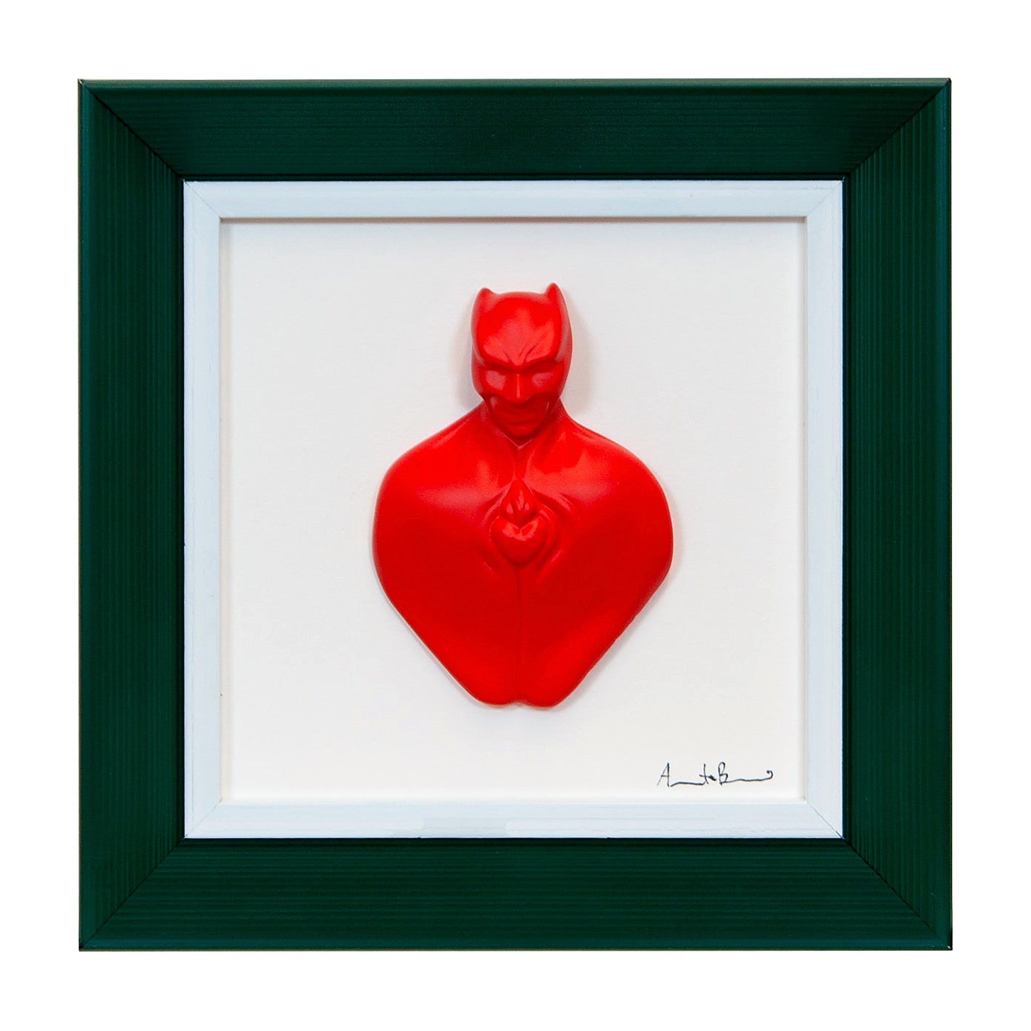 Man in color-scultura in resina opaca rossa con cornice verde scuro in quadro fondo bianco